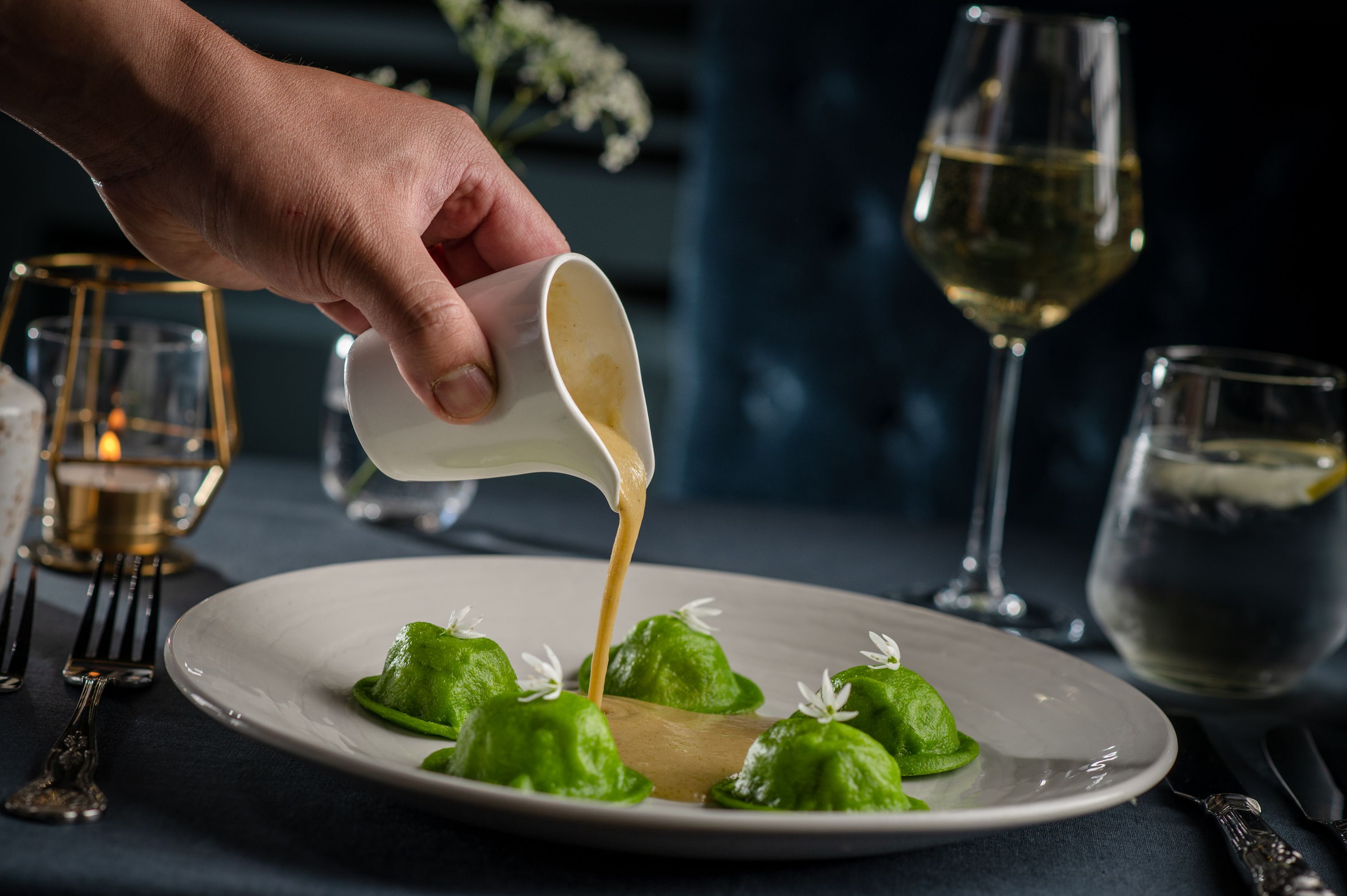 sauce being poured onto plate with pasta